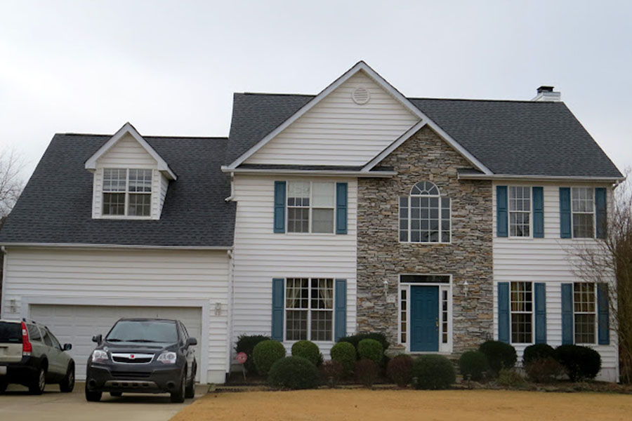 Two-story house with new shingle roofing