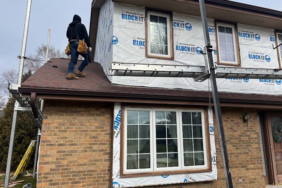 Siding installation in progress on home in Caledonia