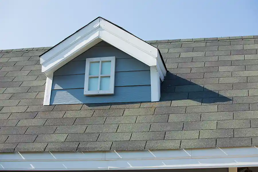 Close-up of gray shingle roof dormer