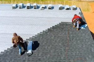 Roofers installing new asphalt shingles