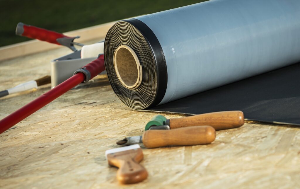 Roll of Modern EPDM Roofing Rubber Material and Some Tools.